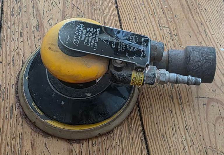 Mirka ROS650CV air orbital sander, still works well but shows signs of use.