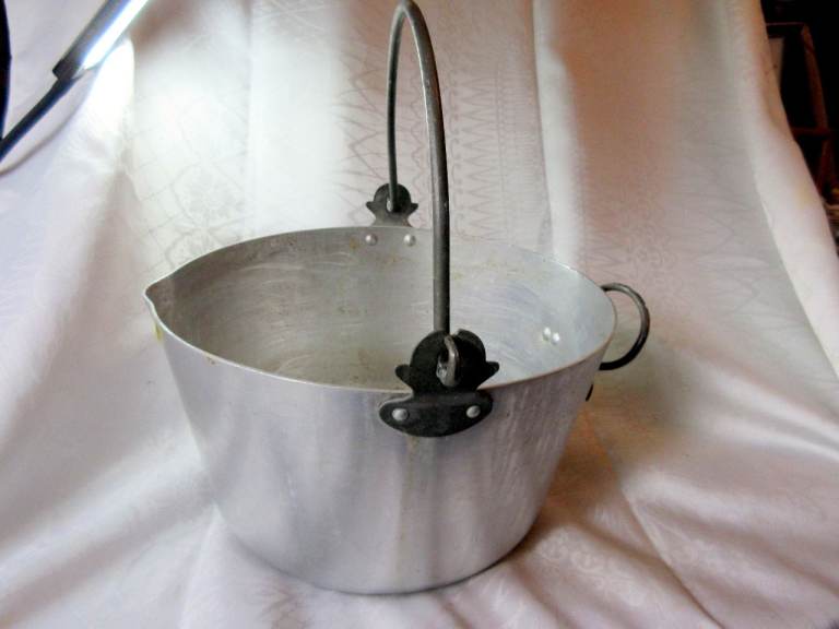 A VINTAGE METAL JAM MAKING PAN