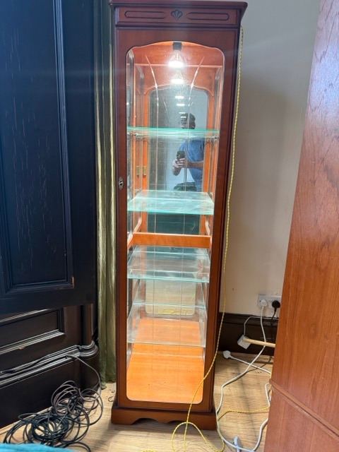 Glass panel wooden cabinet with mirrored rear