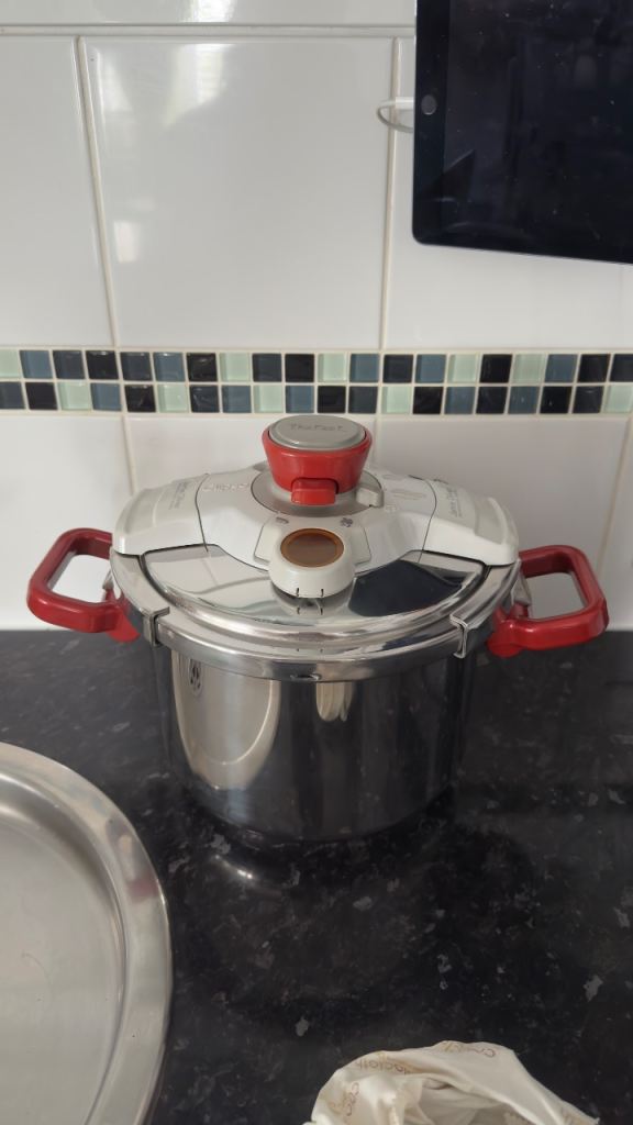 Tefal Stainless Steel Pressure Cooker with Red Handles – Good Condition