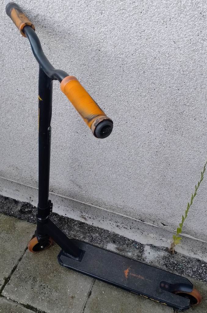 Black Stunt Scooter with Orange Grips – Fair Condition