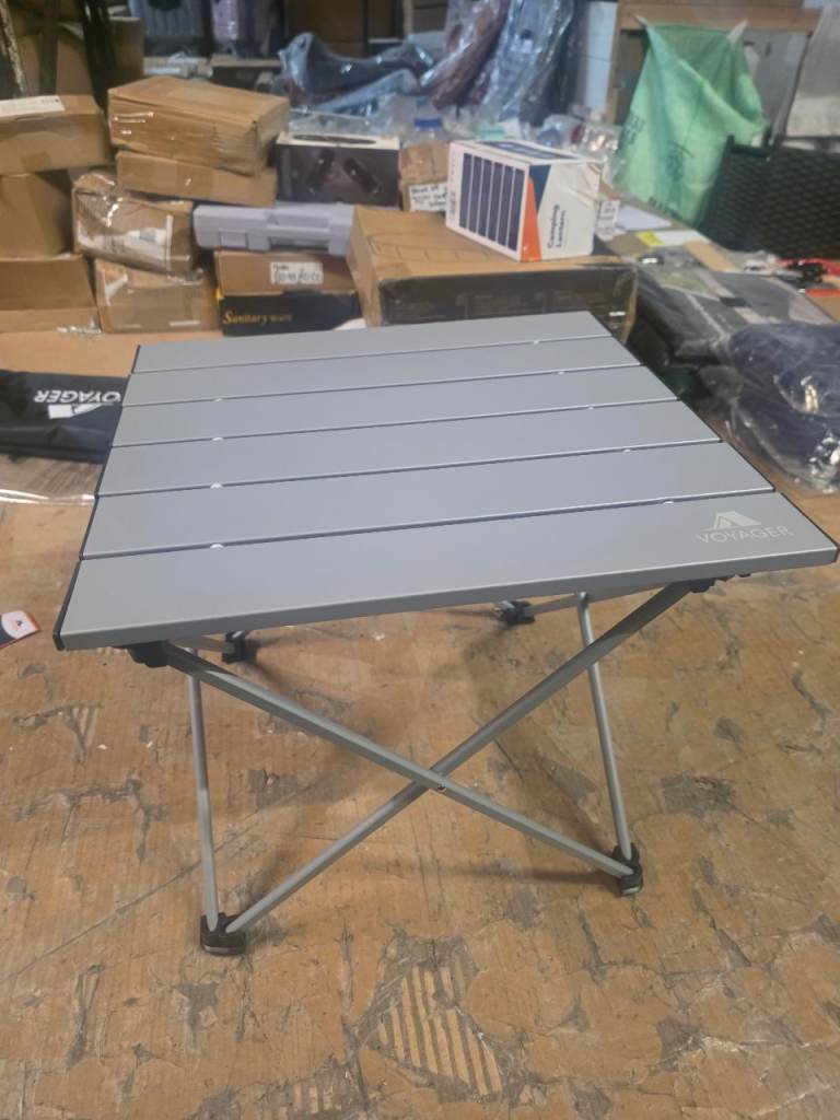 A new silver grey aluminium small folding camping table with carring bag.