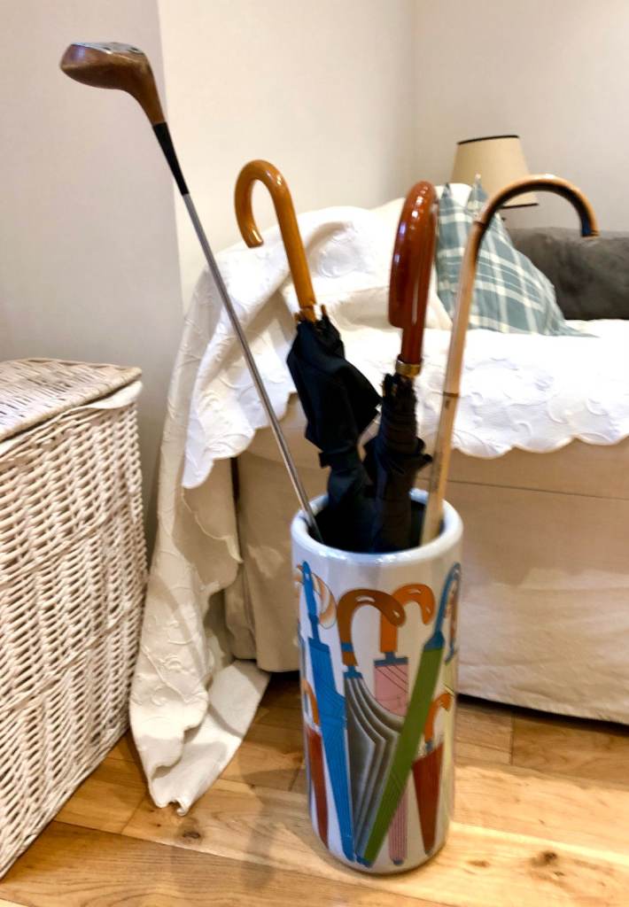 Vintage umbrellas hold with decorative items