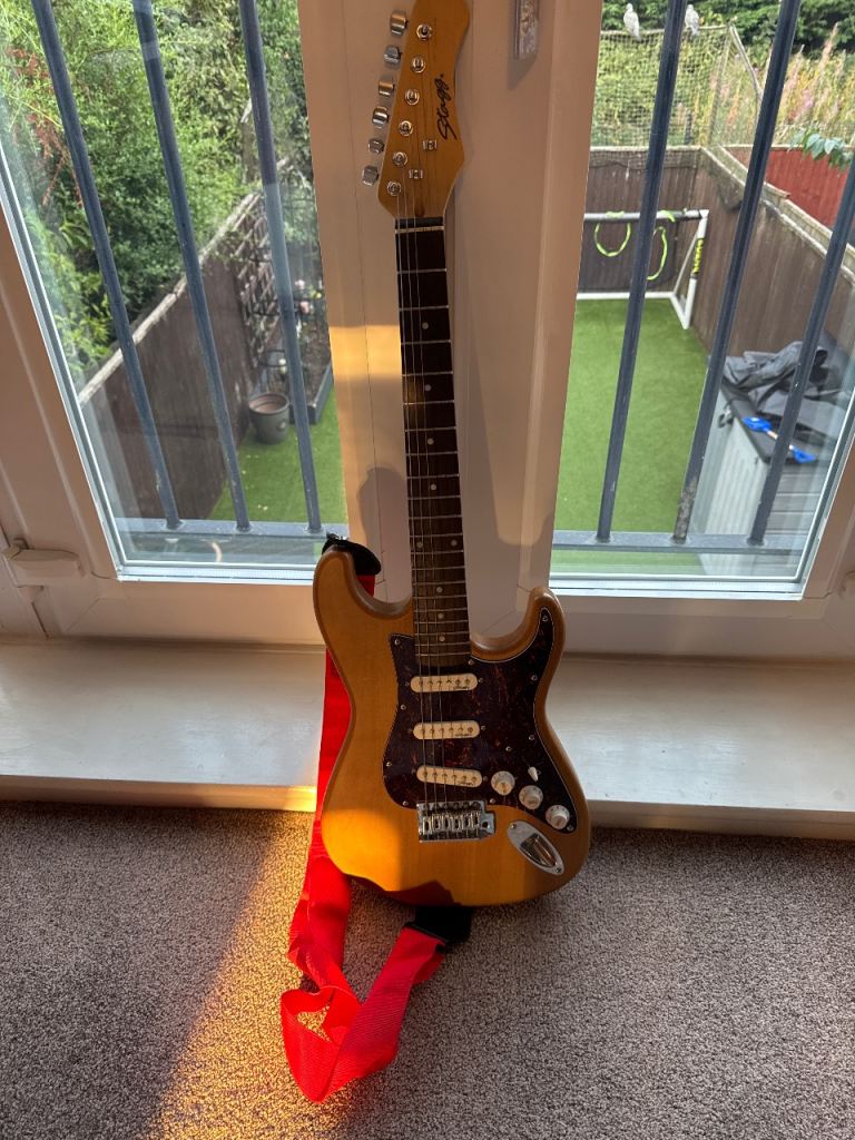 Rocket Electric Guitar with Red Strap – Good Condition