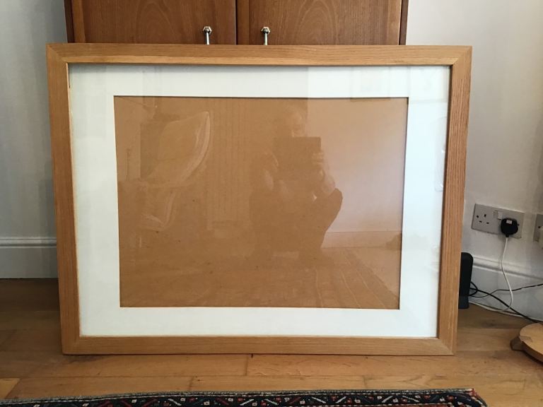 A large, solid oak picture frame.