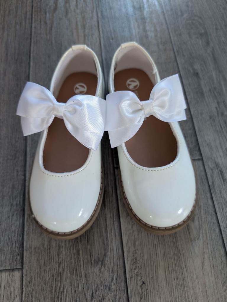 Girls white patent shoes with bows