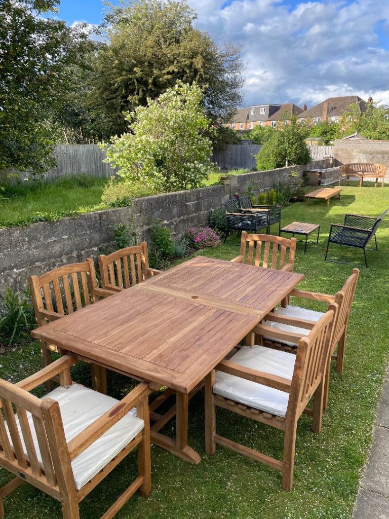 Large teak extendible garden table with six chairs 