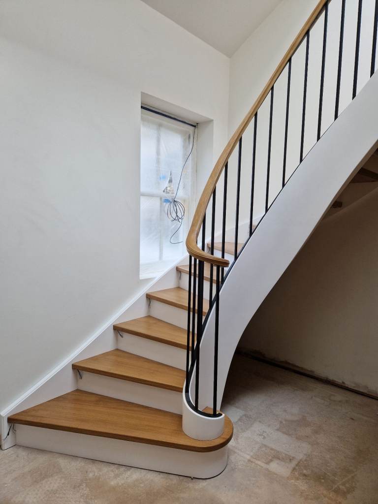 Curved oak staircase with iron banister from Poland