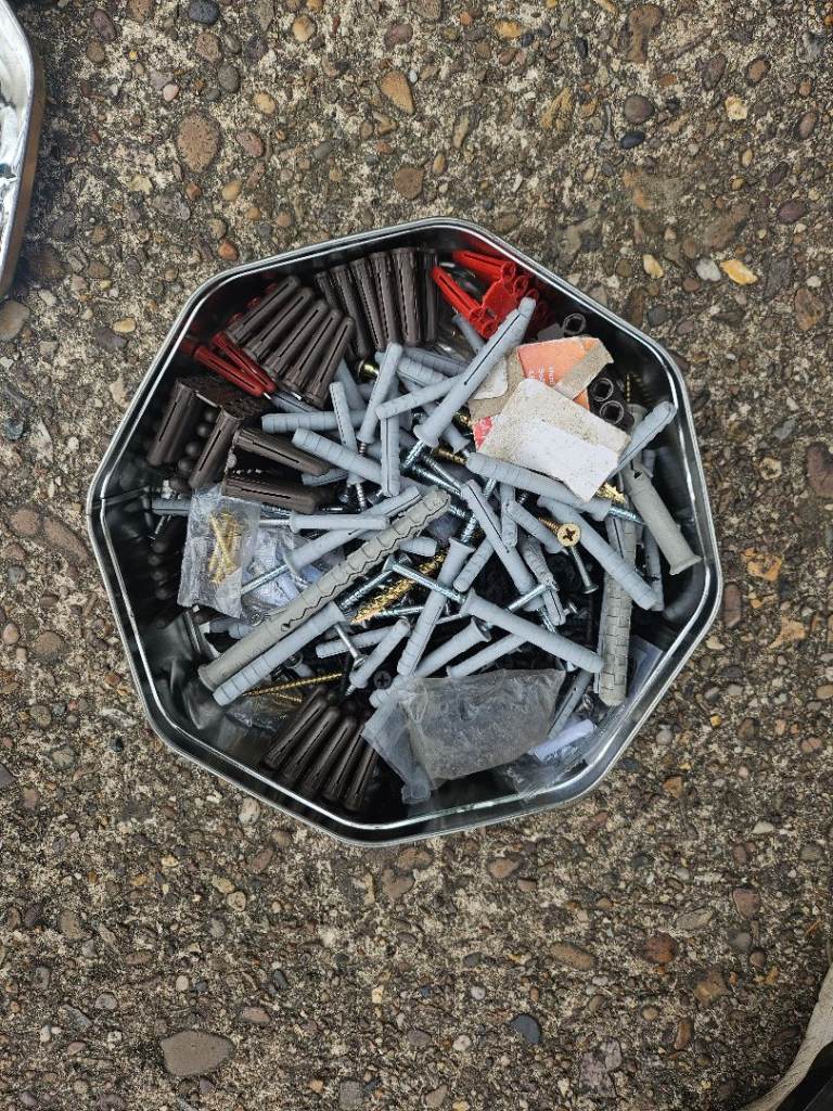 Tin full of various fixings and plugs 