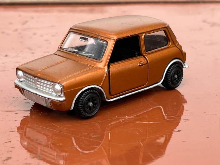 Vintage Dinky Toys 178 Mini Clubman in metallic bronze with opening doors.