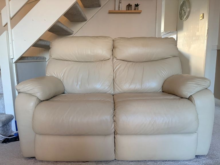 2 cream leather sofas and footstool