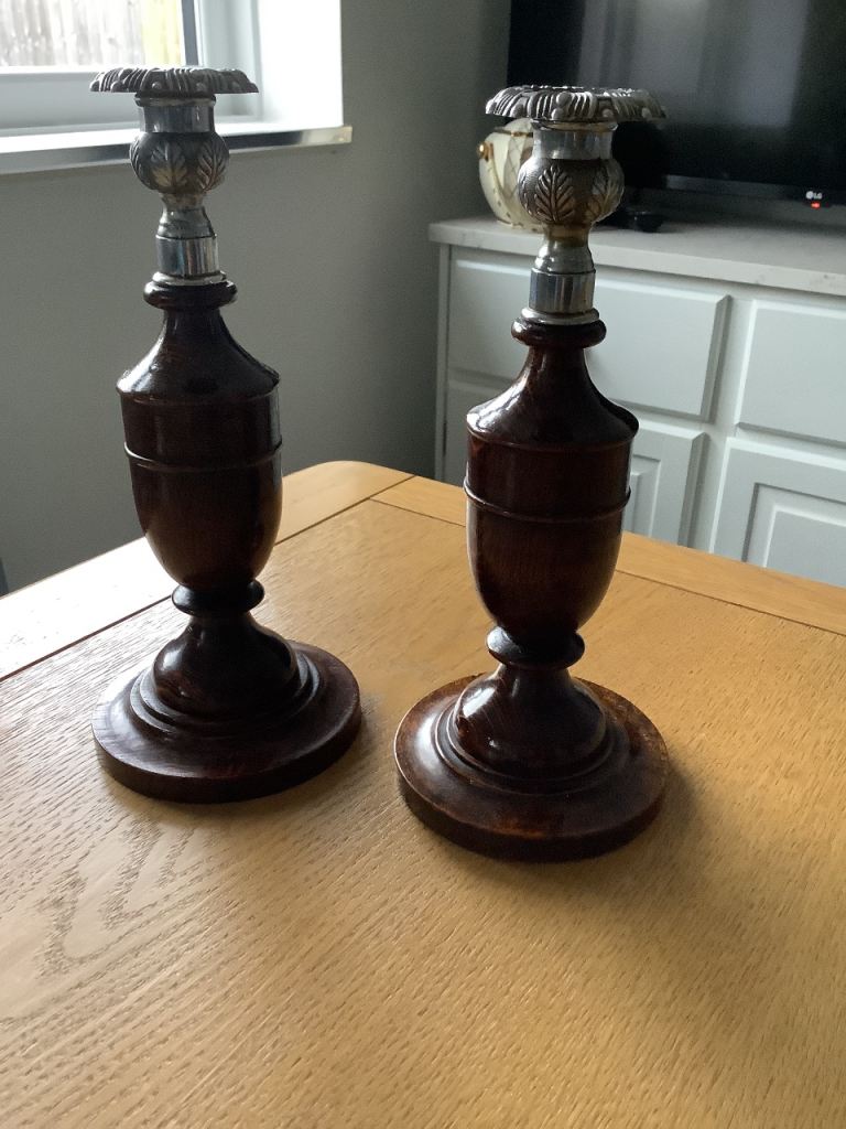 A Pair Of Wood And White Metal Candlesticks.