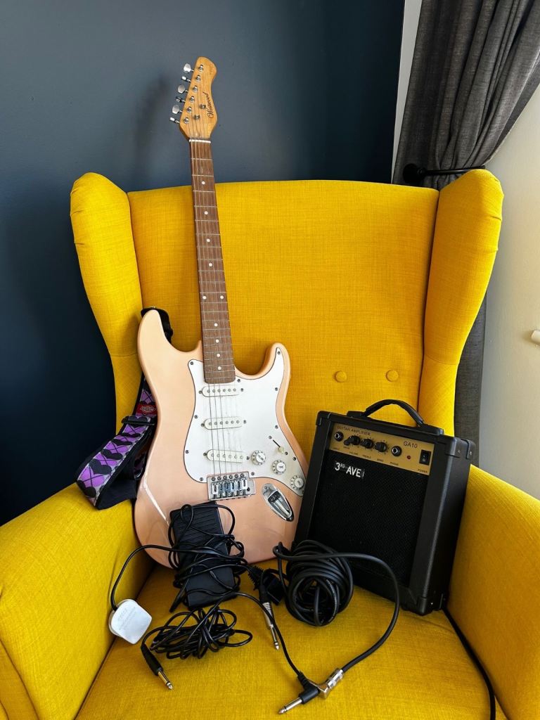 Electric guitar with amp, pedal and two power-connecting cables
