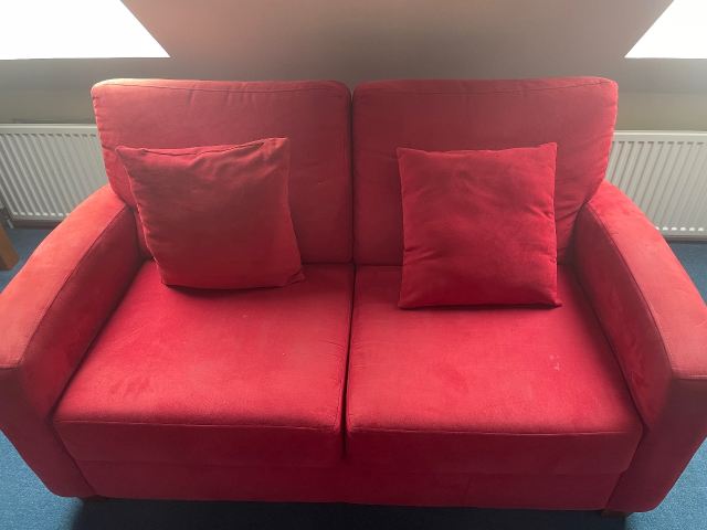 Comfortable Red 2-Seater Sofa with Cushions – Good Condition for Sale