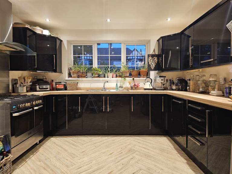 Modern Gloss Black Kitchen Units with Wood Effect Worktop & Handles
