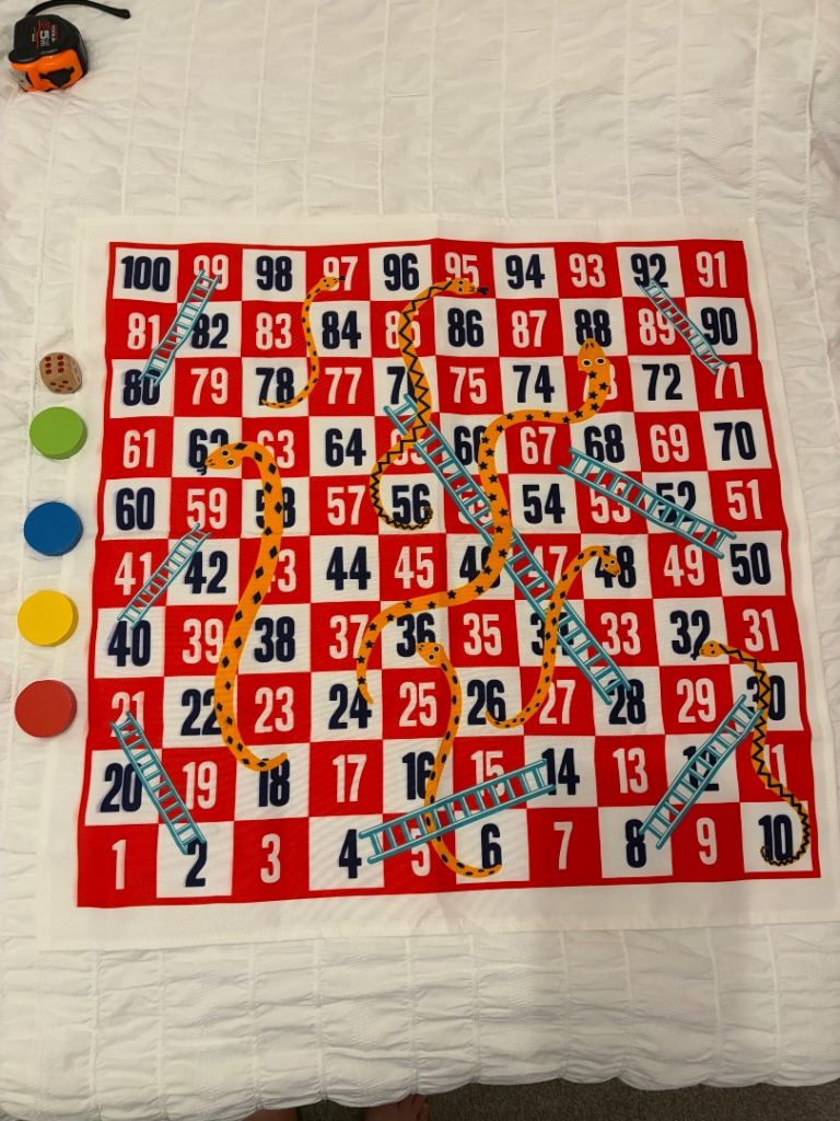 Large fabric Snakes and Ladders game.