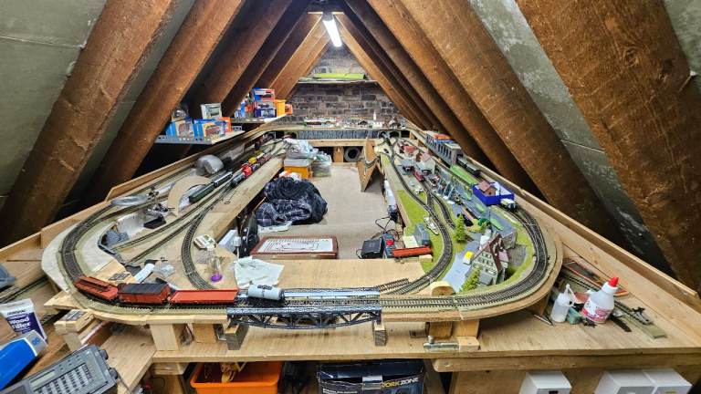 Train set with variety of buildings, people, miscellaneous items and wires etc