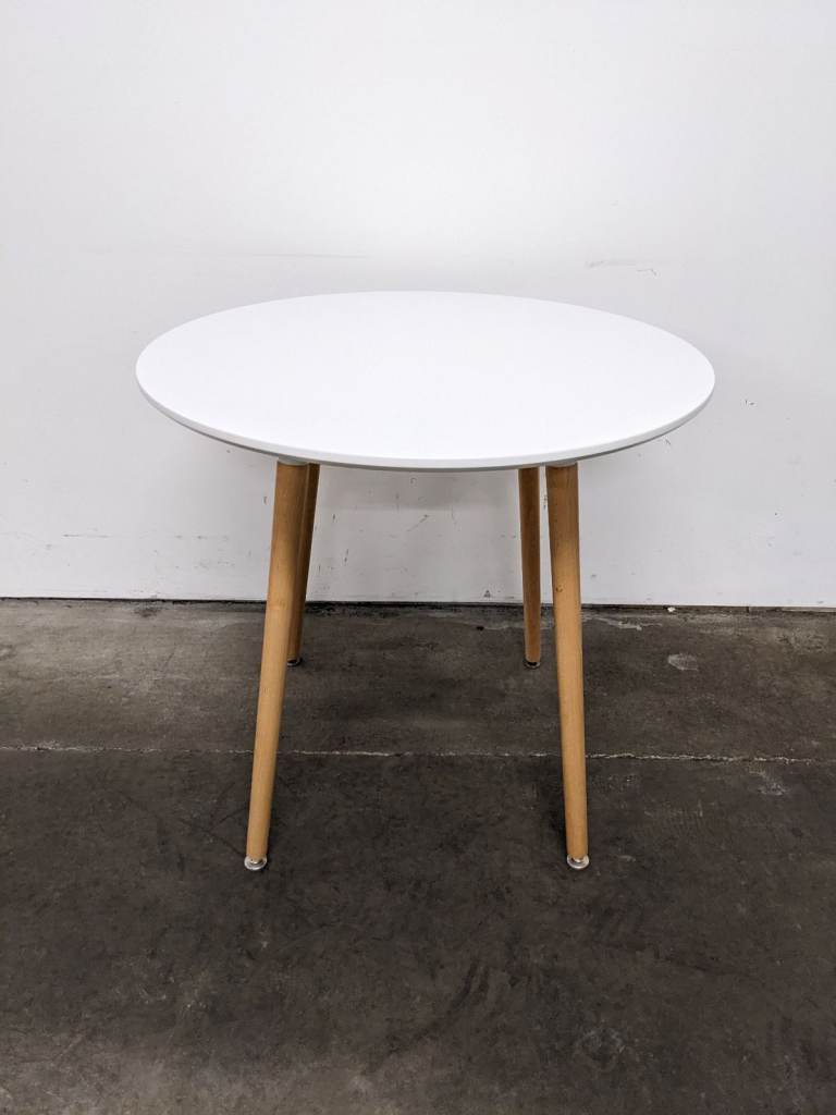 White wooden circular dining table 