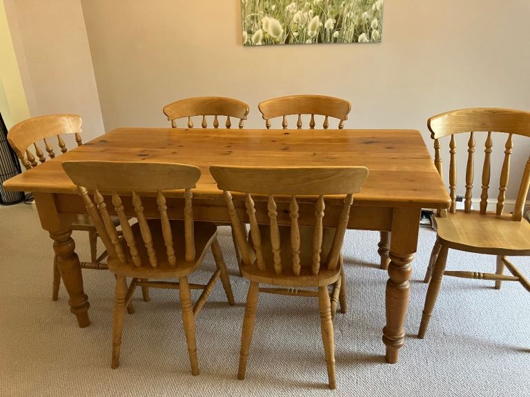 Solid wooden dining table with 6 matching chairs 