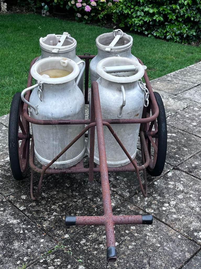 Milk churns x4 in metal cart