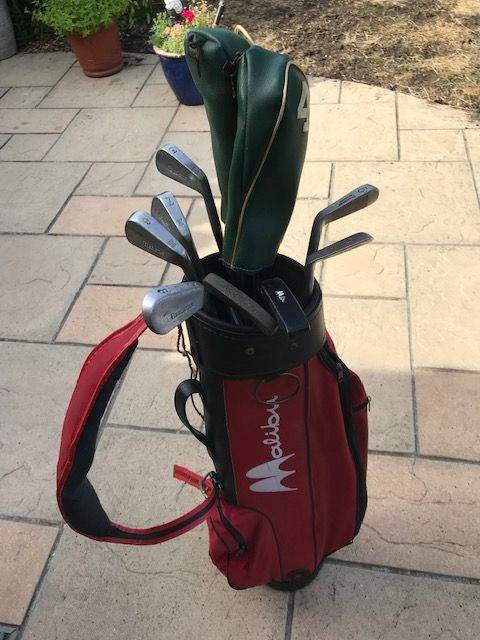 Red Malibu golf bag with vintage clubs