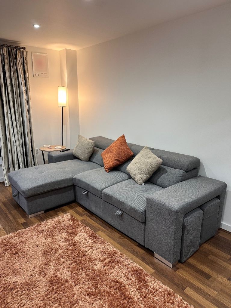 Grey Fabric Corner Sofa with Storage and Pull-Out Bed