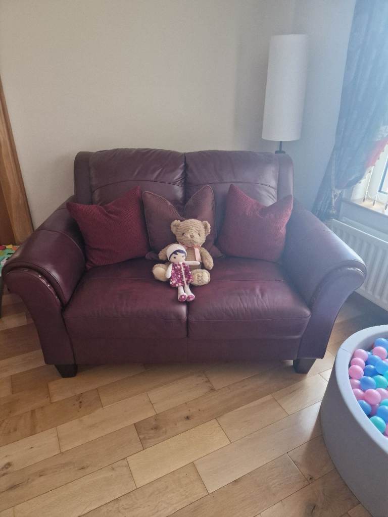 Burgundy/Maroon Leather 3 and 2 seater with foootstool storage box