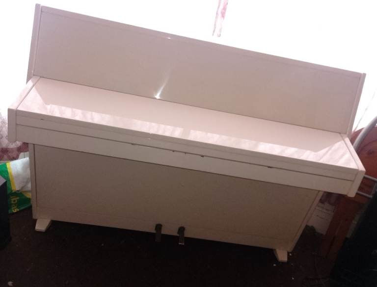 Beautiful ivory coloured piano 
