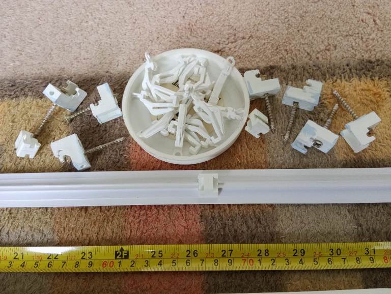 2 pieces of coving and one plastic curtain rail with fixings