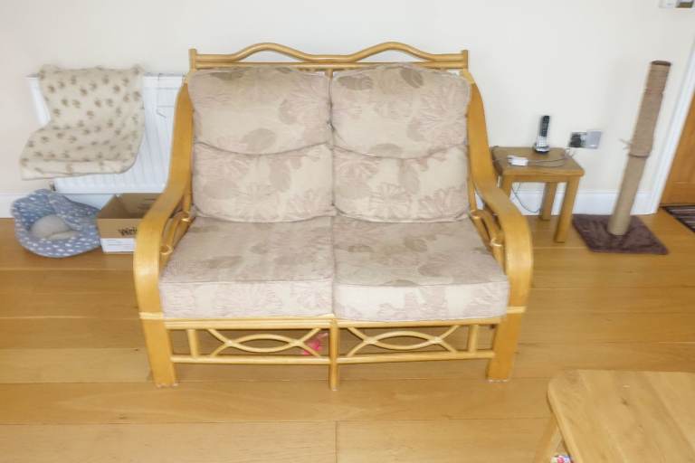 Two bamboo and hardwood small sofas.