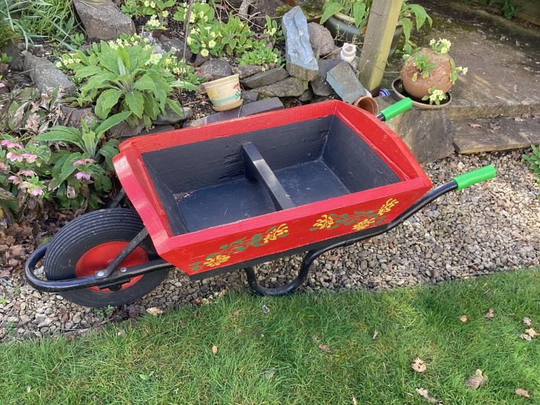 Decorated painted wooden wheelbarrow planter