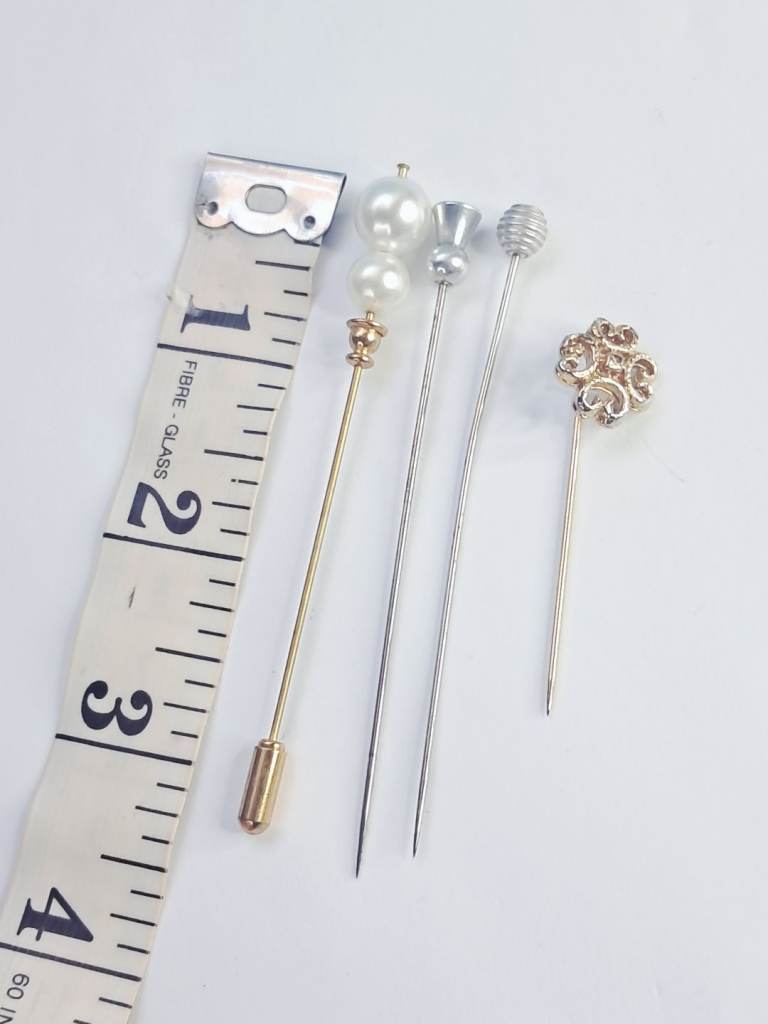 Vintage decorative hijab pins with pearl and floral metal accents.