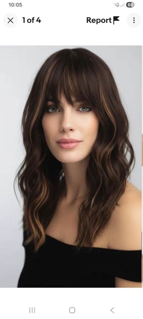 Medium length,wavy dark brown wig, bangs. 