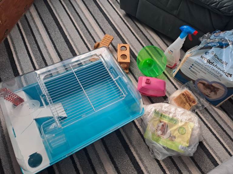 Hamster cage, accessories and bedding. 
