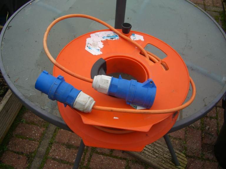 Caravan or motorhome electric hook up cable and reel
