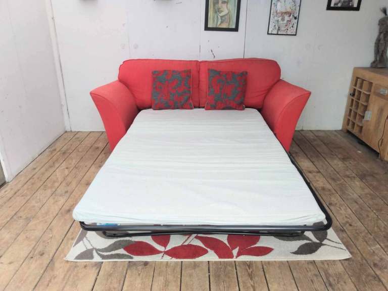 Two seater fabric sofa-bed in red-very good condition