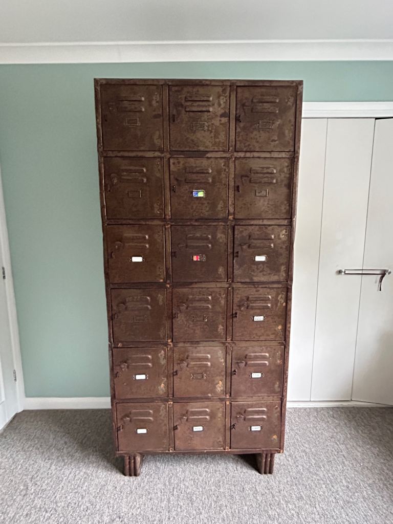 Vintage military metal locker - 18 no. compartments, feet mounted, brown tones