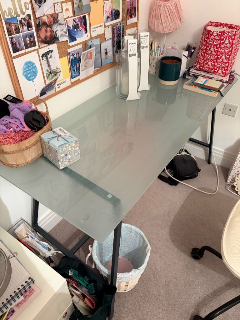 Glass desk with metal supports 