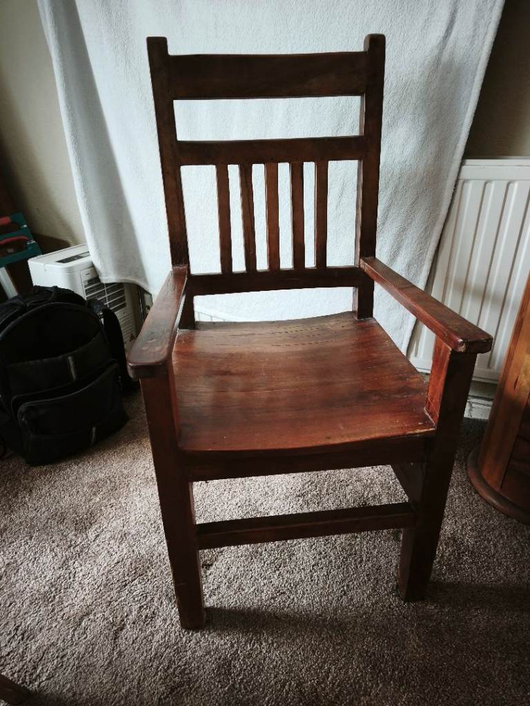 Large solid wooden chair with arms
