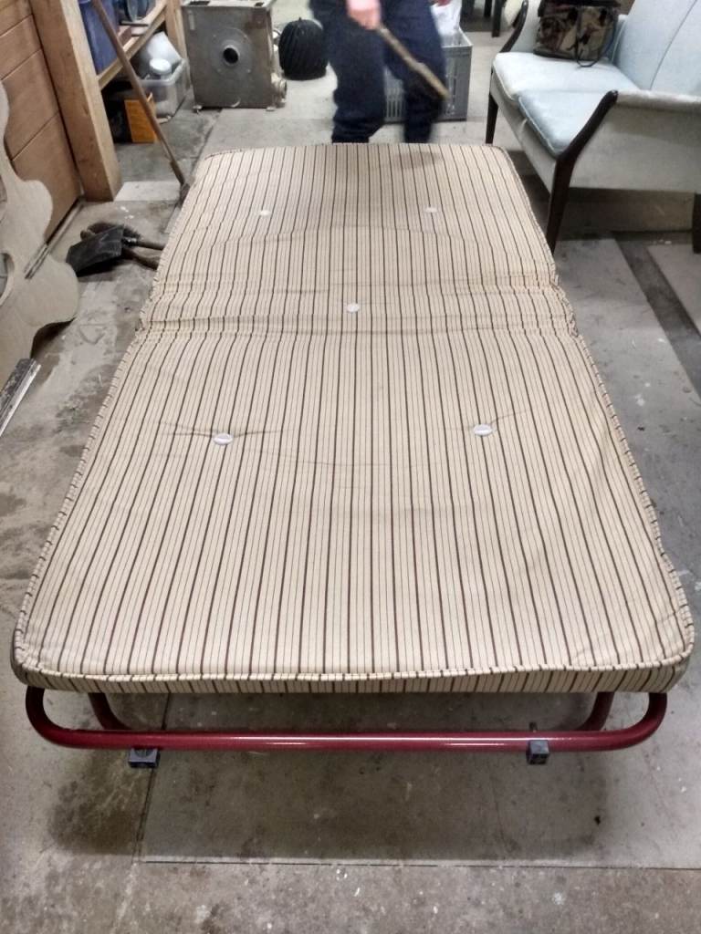 Single folding bed. Portable guest bed. Foam mattress and wheels. 