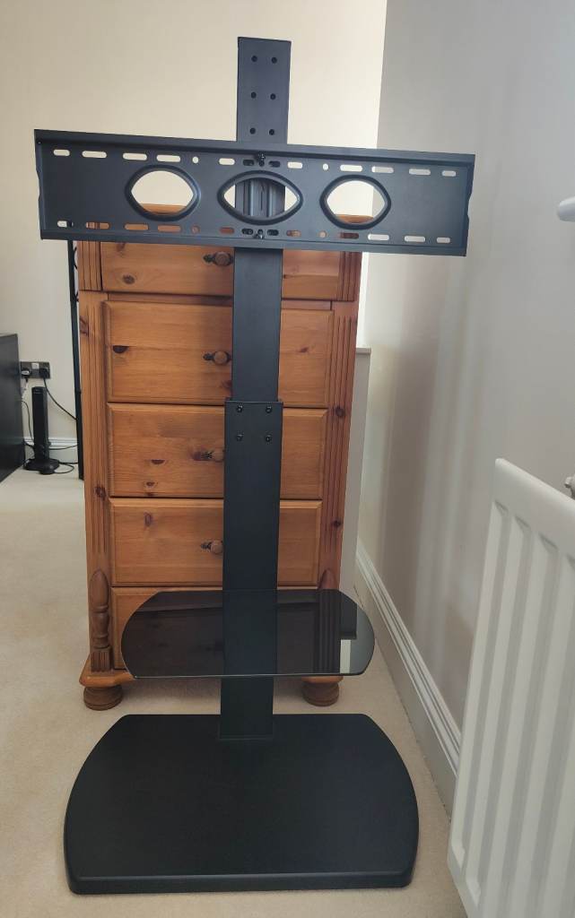 Black TV stand with brackets and shelf