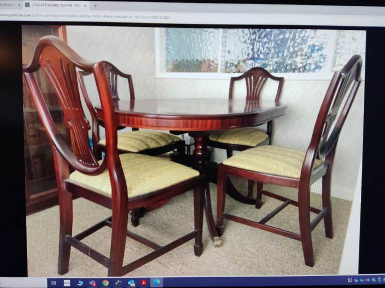 Stag Mahogany dinner table and four chairs.