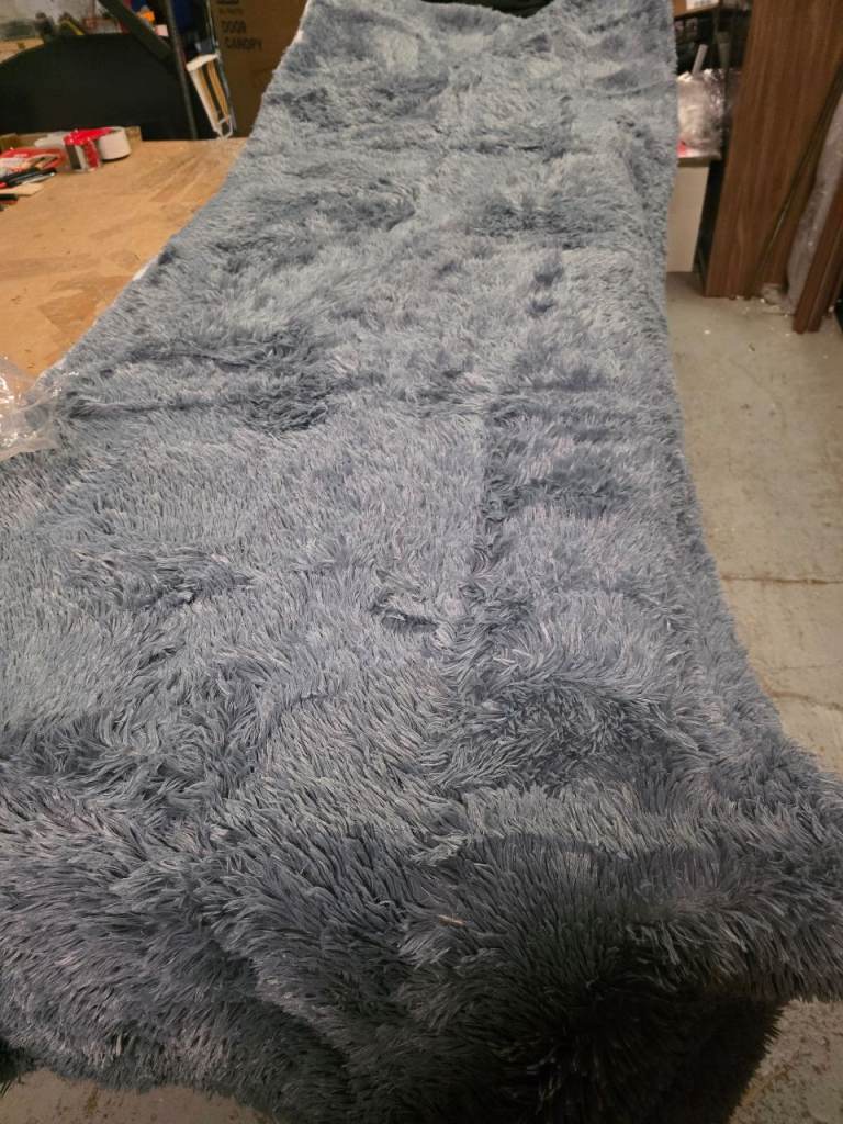 A new large grey fluffy rug the measurements are 210cms width 290cms 