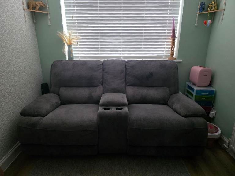 Recliner sofa with storage and drinks holders in centre