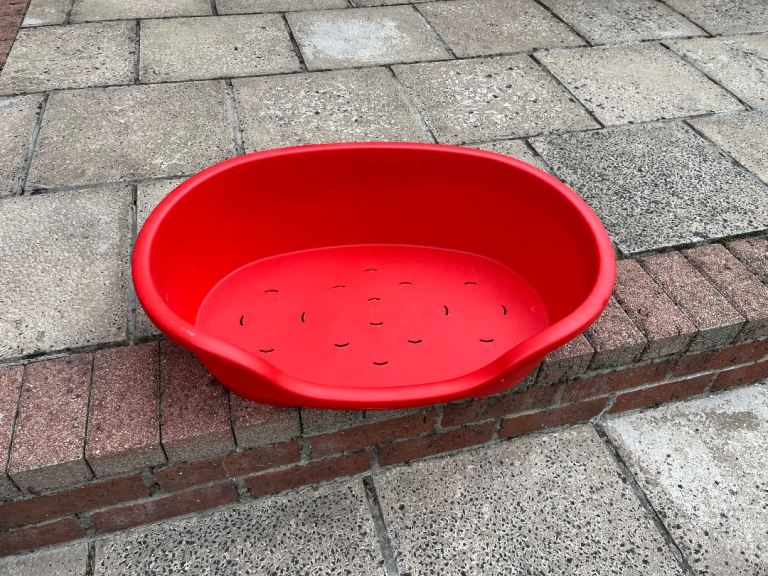 Red plastic dog bed