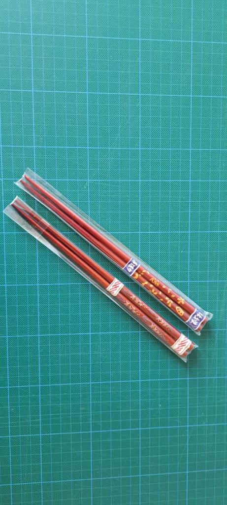 TWO PAIRS OF VINTAGE CHINESE CHOPSTICKS. TRADITIONAL LACQUERED WOOD RED AND GOLD. REUSABLE. SEALED