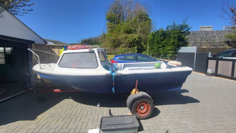 Small Fishing Boat with Outboard Motor and Trailer