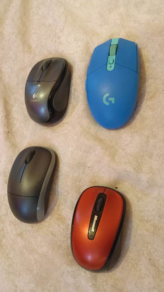 bundle of four wireless computer mice, including Logitech and Microsoft brands.