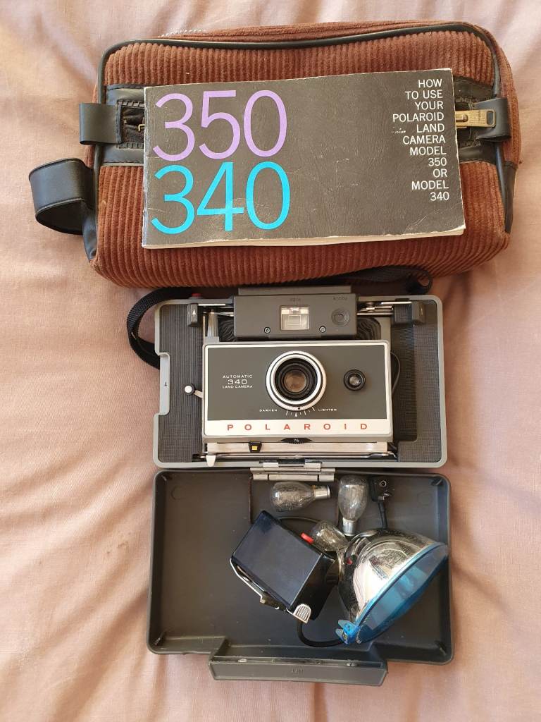 Polaroid340 Automatic Land Camera and Model268 Flash Unit with Bulbs and Case.