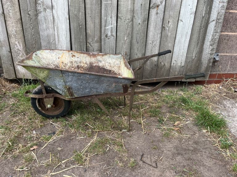 Old vintage metal wheelbarrow planter
